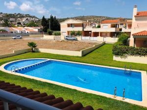 a swimming pool in the yard of a house at PROALMAR, chalet 17 in Peñíscola