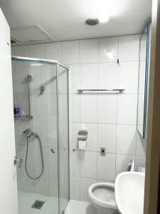 a bathroom with a shower and a toilet and a sink at Incheon Airport Guesthouse in Incheon