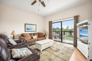 a living room with a couch and a table at Ocean Village Club Q32, 2 Bedrooms, Sleeps 6, Ocean View, Pet Friendly in Butler Beach