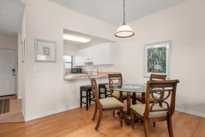 a dining room and kitchen with a table and chairs at Ocean Village Club Q32 in Butler Beach