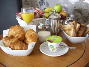 a table with a breakfast of croissants and bread at Higher Faugan Parc in Penzance