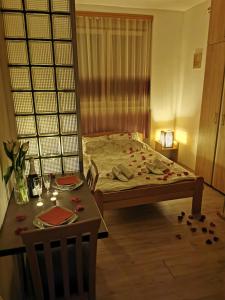 a bedroom with a bed and a table and chairs at Apartments Take a Break Novi Sad in Novi Sad