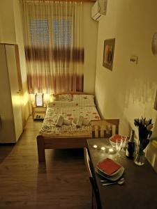 a bedroom with a bed and a table with a tableablish at Apartments Take a Break Novi Sad in Novi Sad