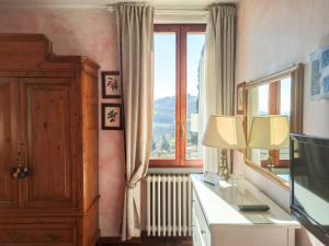 a room with a window and a desk with a computer at Domus Volumnia Country House in Perugia