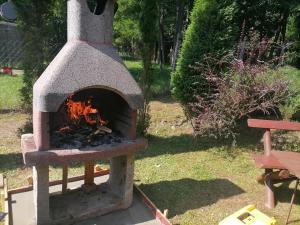 a brick oven with a fire inside of it at Parádóhuta Apartman in Parád