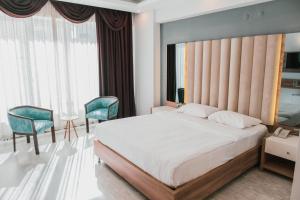 a bedroom with a large bed and two chairs at INN TOWN HOTEL in Eskisehir +57 photos