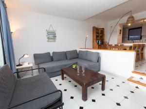 a living room with a couch and a table at Apartment Ducado Golf B II by Interhome in Pals