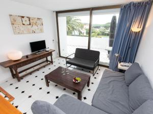 a living room with a couch and a table at Apartment Ducado Golf B II by Interhome in Pals