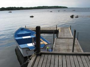 mała łódź przywiązana do przystani nad jeziorem w obiekcie Holiday Home Möcklö - B w mieście Möcklö