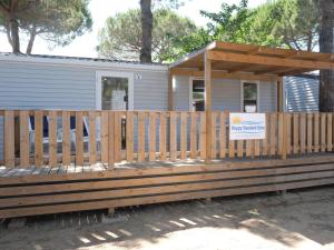 a mobile home with a wooden deck with a porch at Holiday Home Internazionale Manacore by Interhome in Peschici