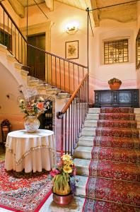 a staircase with a table and flowers on it at Albergo Bellavista in Limone sul Garda