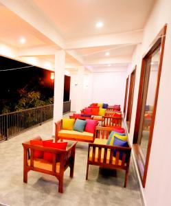 a row of chairs with colorful cushions on a balcony at Milano Grand in Dambulla