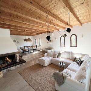 a living room with a white couch and a fireplace at Island House Osljak in Preko