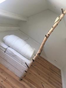 a stick laying on a bed in a room at Domus Damme in Damme