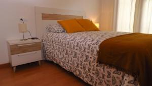 a bedroom with a bed and a nightstand with a bed sidx sidx sidx sidx at APARTAMENT VALL D´EBO in Vall de Ebo