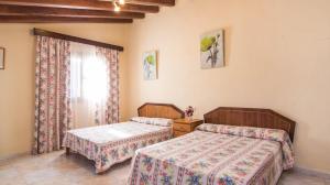 a bedroom with two beds and a window at Finca Es Revolt de Sa Barrala in Campos +18 photos