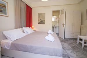 a bedroom with a large bed with towels on it at Prince Studios in Sami