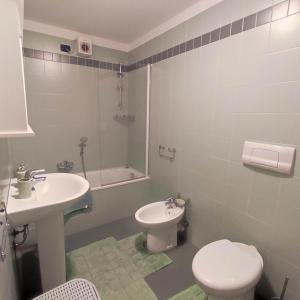 a bathroom with a toilet and a sink at MAISON PLATONE in Alessandria +11 photos