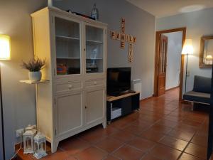 a living room with a large white hutch at Lo corralet in Torre del Compte