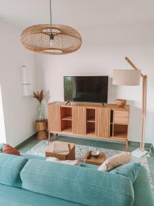 Televízia a/alebo spoločenská miestnosť v ubytovaní Les Villas Mandju