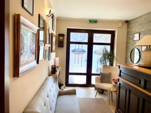 a living room with a couch and a window at Pensiunea Marylou in Alba Iulia