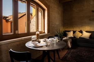a living room with a table and a couch at Borgo Olivo in Pietrelcina