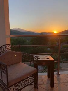 a bench and a table on a balcony with the sunset at VILLA ELYSIUM, Slivno - Makarska in Imotski