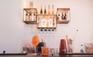 a counter with a drink on a table with bottles at Su Cappeddu Agriturismo in San Giorgio