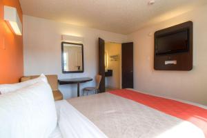 a hotel room with a bed and a flat screen tv at Motel 6-Las Vegas, NV - Tropicana in Las Vegas