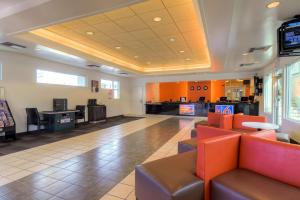 a waiting room with couches and a tv in a hospital at Motel 6-Las Vegas, NV - Tropicana in Las Vegas