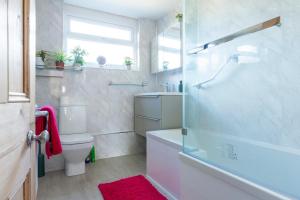 a bathroom with a tub and a toilet and a shower at Hare Cottage in Abergavenny +15 photos