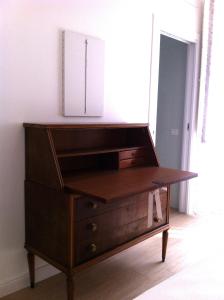a wooden dresser with a mirror on top of it at B&B Majestade in Cagliari