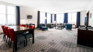 a hotel room with a dining table and a living room at Radisson Blu Hotel Wroclaw in Wrocław