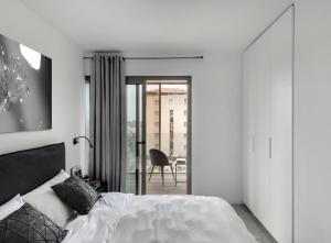 Un pat sau paturi într-o cameră la Yefet - by Beach Apartments TLV