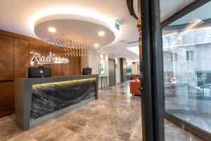 a lobby of a restaurant with a fireplace at Radisson Hotel Istanbul Harbiye in Istanbul