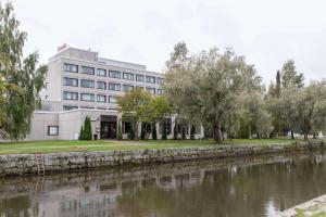 a building next to a river with a building at Scandic Rauma in Rauma