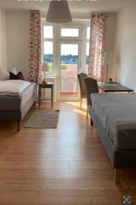 a bedroom with a bed and a desk and a table at Gästewohnung Eberswalde in Eberswalde