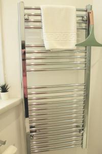 a towel rack with towels on it in a bathroom at Flat 12A - Central, modern, bright apartment with free wifi in Oban