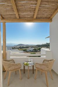 a balcony with a table and chairs and a view at Ruby of Naxos in Agios Prokopios