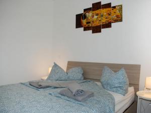 a bedroom with a bed with blue pillows at Apartment Charming Gardenview App- 102 by Interhome in Bissone +9 photos