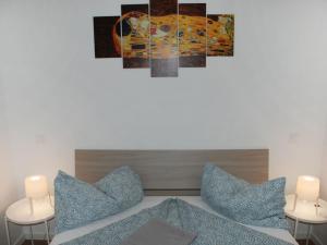 a room with a couch with pillows and a painting at Apartment Charming Gardenview App- 102 by Interhome in Bissone