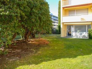 a yard with a tree and a building at Apartment Residenza Lido Appartment 011 by Interhome in Locarno +18 photos