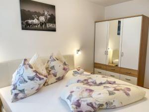 um quarto com uma cama com almofadas e um espelho em Apartment Fankhauser by Interhome em Piesendorf