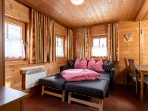 a room with a bed in a wooden cabin at Holiday Home Lindenalm by Interhome in Schwendau