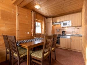 a dining room with a wooden table and chairs at Holiday Home Lindenalm by Interhome in Schwendau