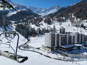 a ski resort in the snow on a ski lift at Studio Rosablanche D63 by Interhome in Siviez