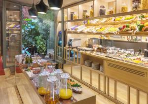 a restaurant with a counter with a lot of food at Hotel Àmbit Barcelona in Barcelona