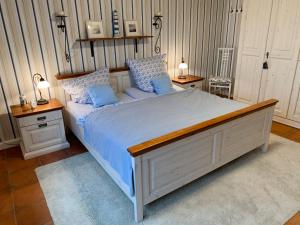 a bedroom with a large bed with blue pillows at Holiday Home Witten by Interhome in Moorweg