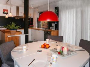 a kitchen with a white table with fruit and candles at Apartment Am Sternberg 250 by Interhome in Frankenau