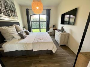 a bedroom with a large bed and a window at La Chambre Cézanne in Aix-en-Provence